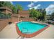 Community swimming pool with lounge chairs surrounded by a brick wall and lush greenery at 1261 Lavista Rd # N4, Atlanta, GA 30324