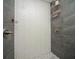 Shower with tiled walls, pebble floor, modern fixtures and convenient shelving at 1261 Lavista Rd # N4, Atlanta, GA 30324