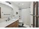 Modern bathroom with white subway tile, black and white floors and a wood vanity at 2049 Oakview Se Rd, Atlanta, GA 30317