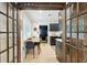 Dining area featuring a modern style with hardwood floors, glass paneled doors and a view into the kitchen at 2049 Oakview Se Rd, Atlanta, GA 30317