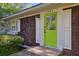 Close-up of a home's bright green front door, cedar shake siding and white trim at 2049 Oakview Se Rd, Atlanta, GA 30317