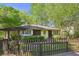 Cozy home with a brown picket fence, brown cedar shake siding and a bright green front door at 2049 Oakview Se Rd, Atlanta, GA 30317
