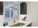 Bright kitchen featuring stylish backsplash, stainless steel sink, and modern fixtures at 2049 Oakview Se Rd, Atlanta, GA 30317