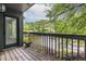 Balcony with wooden floors offering views of landscaped grounds and mature trees at 223 Tuxworth Cir, Decatur, GA 30033