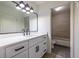 Modern bathroom with a white vanity, dark hardware, and a tiled shower/tub combo at 223 Tuxworth Cir, Decatur, GA 30033