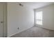 Cozy bedroom with neutral walls, soft carpet, and a window at 223 Tuxworth Cir, Decatur, GA 30033