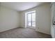 Bedroom with neutral walls, soft carpet, a window with blinds, and a door at 223 Tuxworth Cir, Decatur, GA 30033
