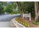 Entrance to Tuxworth Springs community with manicured landscaping and signage at 223 Tuxworth Cir, Decatur, GA 30033