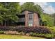 Inviting two-story condo with a brick facade, wooden balcony, and mature landscaping at 223 Tuxworth Cir, Decatur, GA 30033