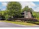 Exterior view of the condo building with well-maintained landscaping at 223 Tuxworth Cir, Decatur, GA 30033