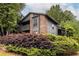 Charming two-story condo boasts a brick facade, wooden balcony, and lush landscaping at 223 Tuxworth Cir, Decatur, GA 30033