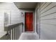 Close-up of the front door, accented by a modern light fixture and gray siding at 223 Tuxworth Cir, Decatur, GA 30033