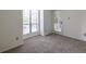 Bright living room with carpet, a door to the outside patio, and a large window at 223 Tuxworth Cir, Decatur, GA 30033