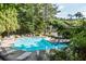 Community pool with sun loungers surrounded by mature trees at 223 Tuxworth Cir, Decatur, GA 30033
