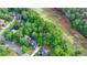 An aerial view shows the neighborhood's mature trees and how the homes are nestled in nature at 2973 Misty Rock Cv, Dacula, GA 30019