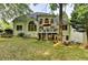 Exterior view of home from the backyard featuring a deck, patio and lush lawn at 2973 Misty Rock Cv, Dacula, GA 30019