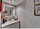 Modest bathroom featuring a single vanity, large mirror, and simple decor at 2973 Misty Rock Cv, Dacula, GA 30019