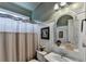 Cozy bathroom with an ornate mirror, patterned shower curtain and decorative accents at 2973 Misty Rock Cv, Dacula, GA 30019