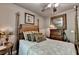 Bedroom with hardwood floors, four-poster bed, ceiling fan and decor at 2973 Misty Rock Cv, Dacula, GA 30019