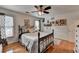 Bedroom features a metal bed frame, wood floors, and natural light, offering a comfortable retreat at 2973 Misty Rock Cv, Dacula, GA 30019