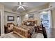 Comfortable bedroom with a ceiling fan, neutral walls, a plush bed, and a seating area at 2973 Misty Rock Cv, Dacula, GA 30019