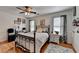 Bedroom featuring a metal bed frame, wood floors, and natural light creates a relaxing retreat at 2973 Misty Rock Cv, Dacula, GA 30019