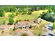 An aerial view shows a manicured golf course and beautiful club house at 2973 Misty Rock Cv, Dacula, GA 30019
