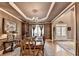 Elegant dining room with coffered ceilings, hardwood floors, and stylish chandelier at 2973 Misty Rock Cv, Dacula, GA 30019