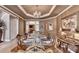 Elegant dining room with tray ceiling, chandelier, and hardwood floors at 2973 Misty Rock Cv, Dacula, GA 30019