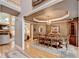 Formal dining room featuring tray ceilings, chandelier, and hardwood floors at 2973 Misty Rock Cv, Dacula, GA 30019