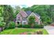 Charming two-story brick home boasts lush landscaping and inviting curb appeal at 2973 Misty Rock Cv, Dacula, GA 30019