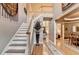 Elegant foyer showcasing staircase, hardwood floors, and seamless transition to living spaces at 2973 Misty Rock Cv, Dacula, GA 30019
