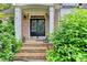 Inviting front entrance with brick steps and decorative foliage at 2973 Misty Rock Cv, Dacula, GA 30019