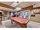 Basement game room with a pool table, kitchenette, and walkout access to backyard at 2973 Misty Rock Cv, Dacula, GA 30019