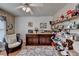 Bright hobby room featuring a ceiling fan, built-in shelving, and dual wooden crafting tables at 2973 Misty Rock Cv, Dacula, GA 30019