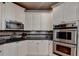 Bright kitchen with granite countertops, stainless steel appliances, and ample white cabinetry at 2973 Misty Rock Cv, Dacula, GA 30019