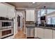Open kitchen featuring stainless steel appliances and granite countertops and view to the living room at 2973 Misty Rock Cv, Dacula, GA 30019