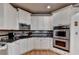Well-appointed kitchen with stainless steel appliances, white cabinetry, and granite countertops at 2973 Misty Rock Cv, Dacula, GA 30019