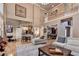 Open-concept living room with high ceilings, hardwood floors, and access to the kitchen at 2973 Misty Rock Cv, Dacula, GA 30019
