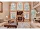 Spacious living room with high ceilings, stone fireplace, and large windows with backyard views at 2973 Misty Rock Cv, Dacula, GA 30019