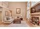 Comfortable living room with fireplace, hardwood floors, and large windows for natural light at 2973 Misty Rock Cv, Dacula, GA 30019
