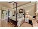 Bright main bedroom with hardwood floors, a four poster bed and ample closet space at 2973 Misty Rock Cv, Dacula, GA 30019