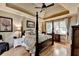 Spacious main bedroom with tray ceiling, four-poster bed, and hardwood floors at 2973 Misty Rock Cv, Dacula, GA 30019