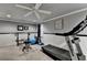 Basement workout room features a treadmill, weight rack, and a ceiling fan at 2973 Misty Rock Cv, Dacula, GA 30019