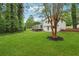 A lush, green backyard with a deck and white siding on the house at 4327 Wellington Hills Ln, Snellville, GA 30039