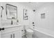 Bathroom features a shower/tub and sink with white cabinets and black hardware at 4327 Wellington Hills Ln, Snellville, GA 30039