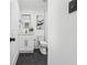 Modern bathroom with sleek black fixtures, white vanity, and tiled floors at 4327 Wellington Hills Ln, Snellville, GA 30039