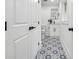 Charming bathroom featuring patterned floors, black hardware, and a modern vanity at 4327 Wellington Hills Ln, Snellville, GA 30039