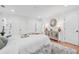 Sunlit bedroom featuring hardwood floors, white walls, and stylish decor elements at 4327 Wellington Hills Ln, Snellville, GA 30039