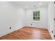 Bedroom with hardwood floors, white walls and trim, and a window view at 4327 Wellington Hills Ln, Snellville, GA 30039